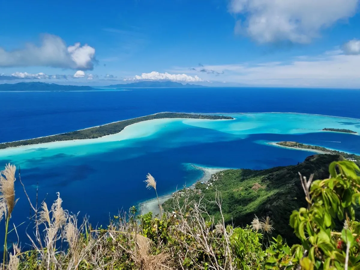 View of Bora Bora's blue lagoon from the Mount Piri hiking trail in French Polynesia