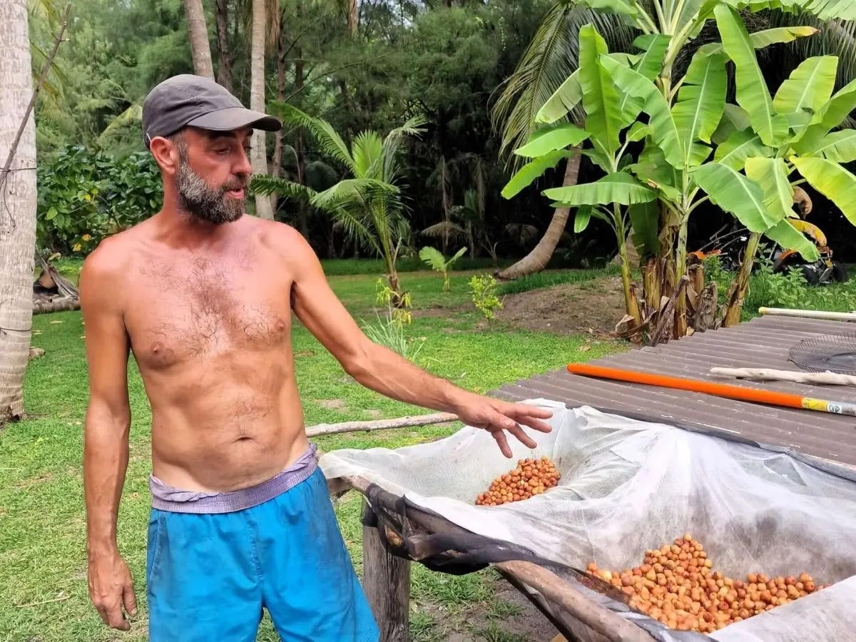 Mica shows off his harvest at his home plantage in Bora Bora