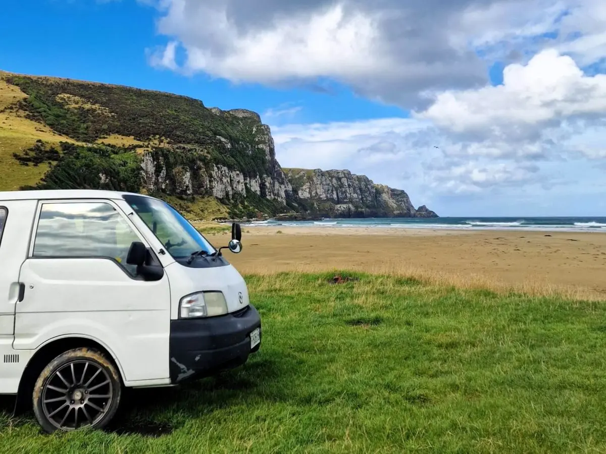 A campervan parked on a beach during a 14-day South Island New Zealand road trip
