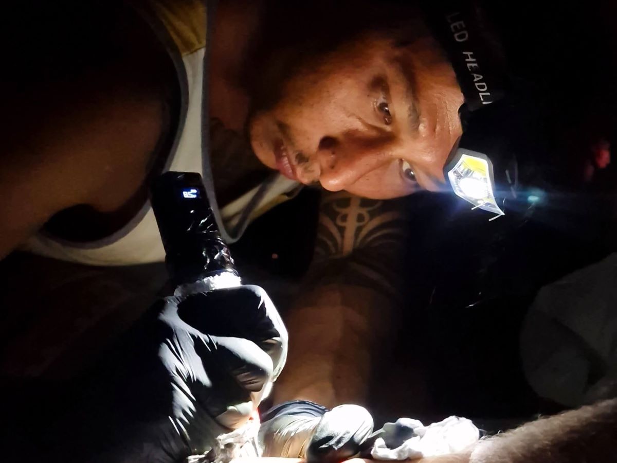 The Polynesian tattoo artist Lolo tattoos in the dark