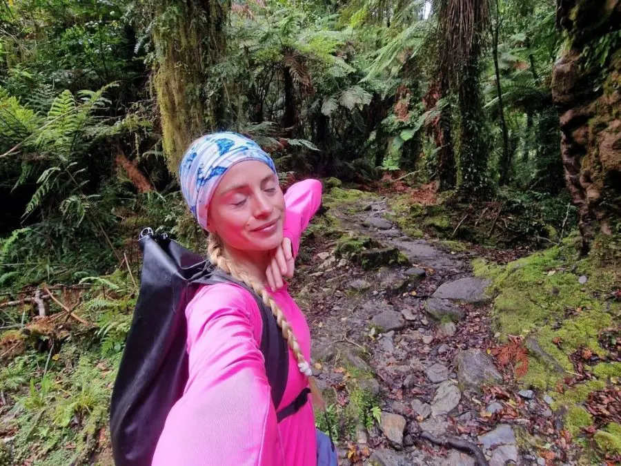A hiker on the Roberts Point Track leading to the Franz Josef Glacier viewpoint