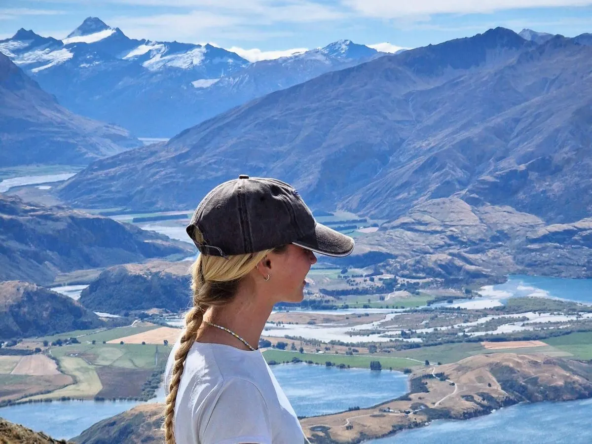 A hiker at the summit of Roys Peak Track near Wanaka, New Zealand