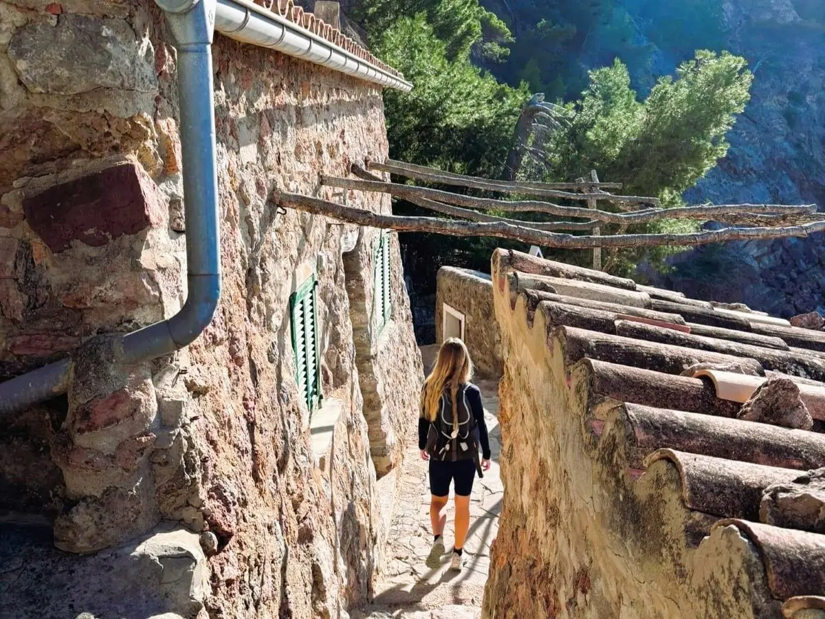 A hiker exploring the Caló de S’Estaca: The Secret Cove Hike Near Valldemossa (2026 Guide)
